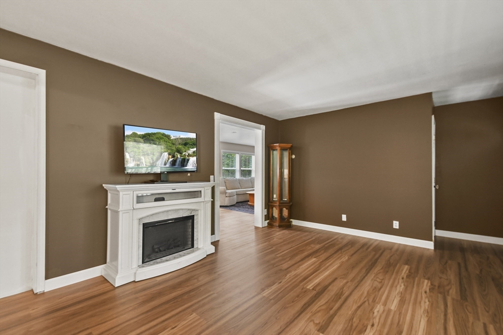 29 Prescott Street Rutland, MA 01543 - Photo 13 of 30 a view of empty room with wooden floor and fireplace