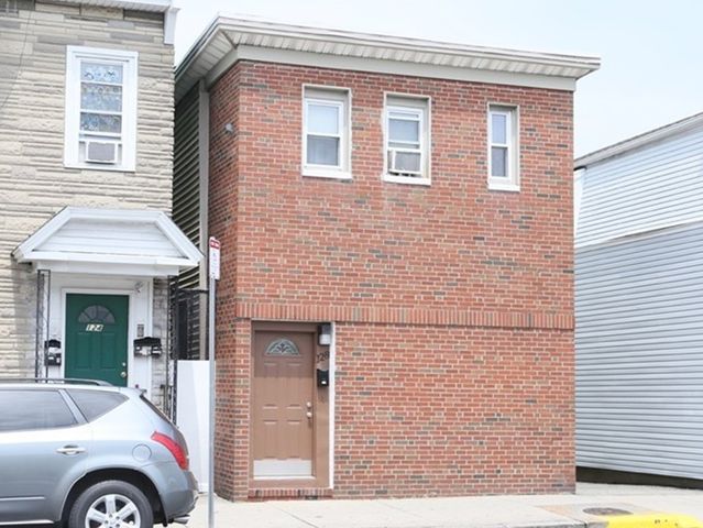 a front view of a house with parking space