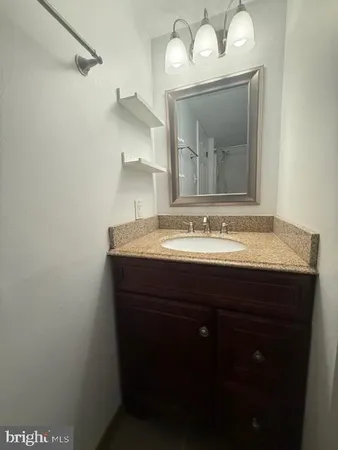 a bathroom with a sink vanity and a mirror