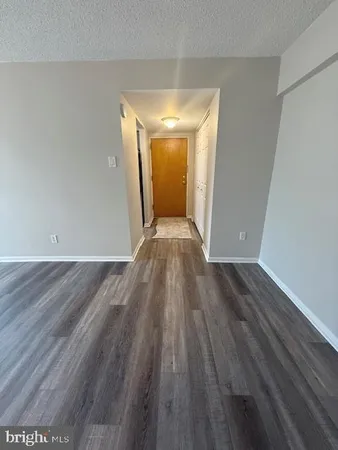 a view of a room with wooden floor