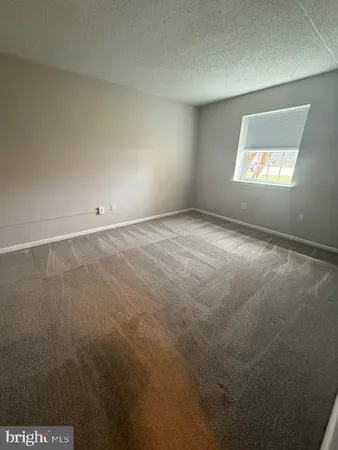 a view of an empty room and a window