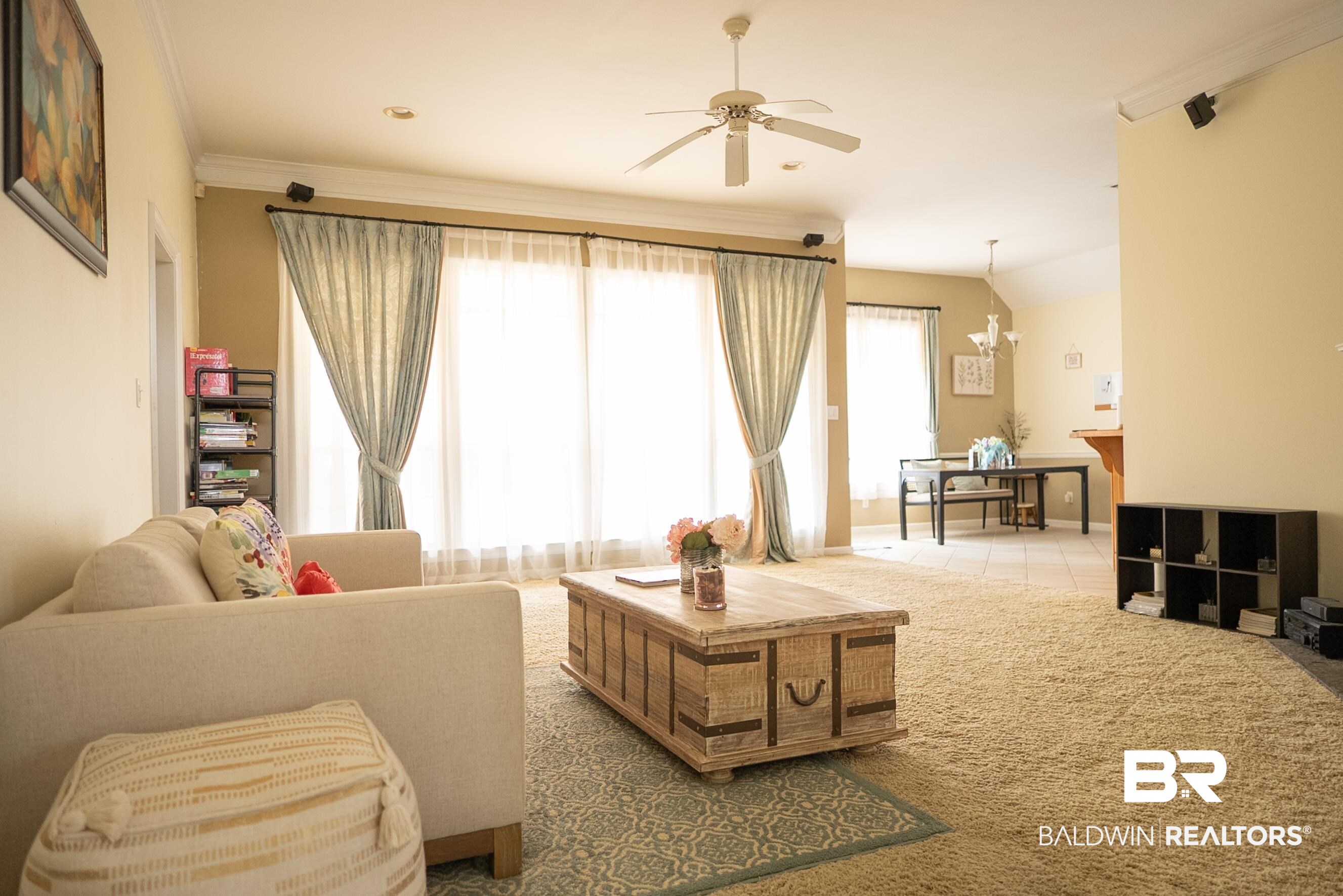 10023 Springfield Court Mobile, AL 36695 - Photo 13 of 50 Living area with a ceiling fan, a chandelier, carpet, and ornamental molding