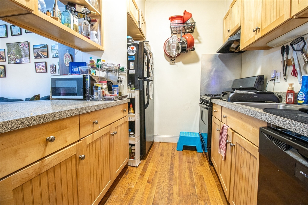 828 Huntington Avenue, Unit 1 Boston, MA 02115 - Photo 5 of 10 a kitchen with stainless steel appliances granite countertop a stove a sink and a cabinets