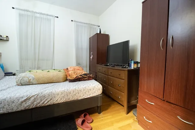 a bedroom with a bed and flat screen tv
