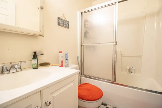 a bathroom with a sink toilet and shower