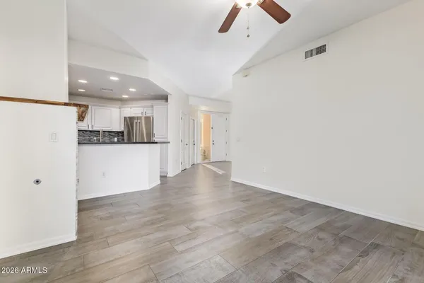 a view of an empty room with a fireplace
