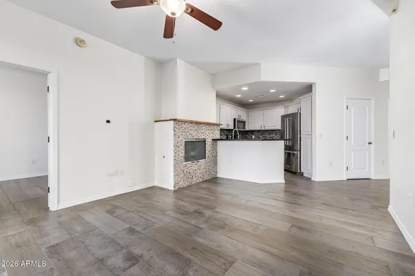 a kitchen with stainless steel appliances kitchen island granite countertop a refrigerator and a stove top oven