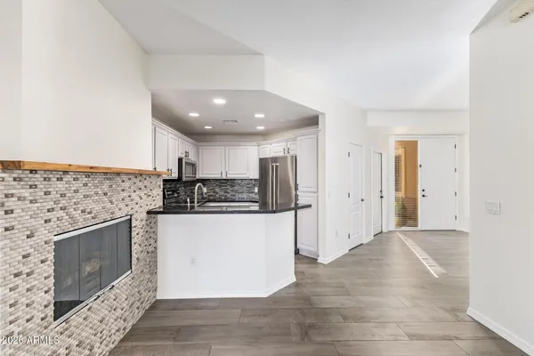 a kitchen with stainless steel appliances granite countertop a stove a refrigerator and a sink
