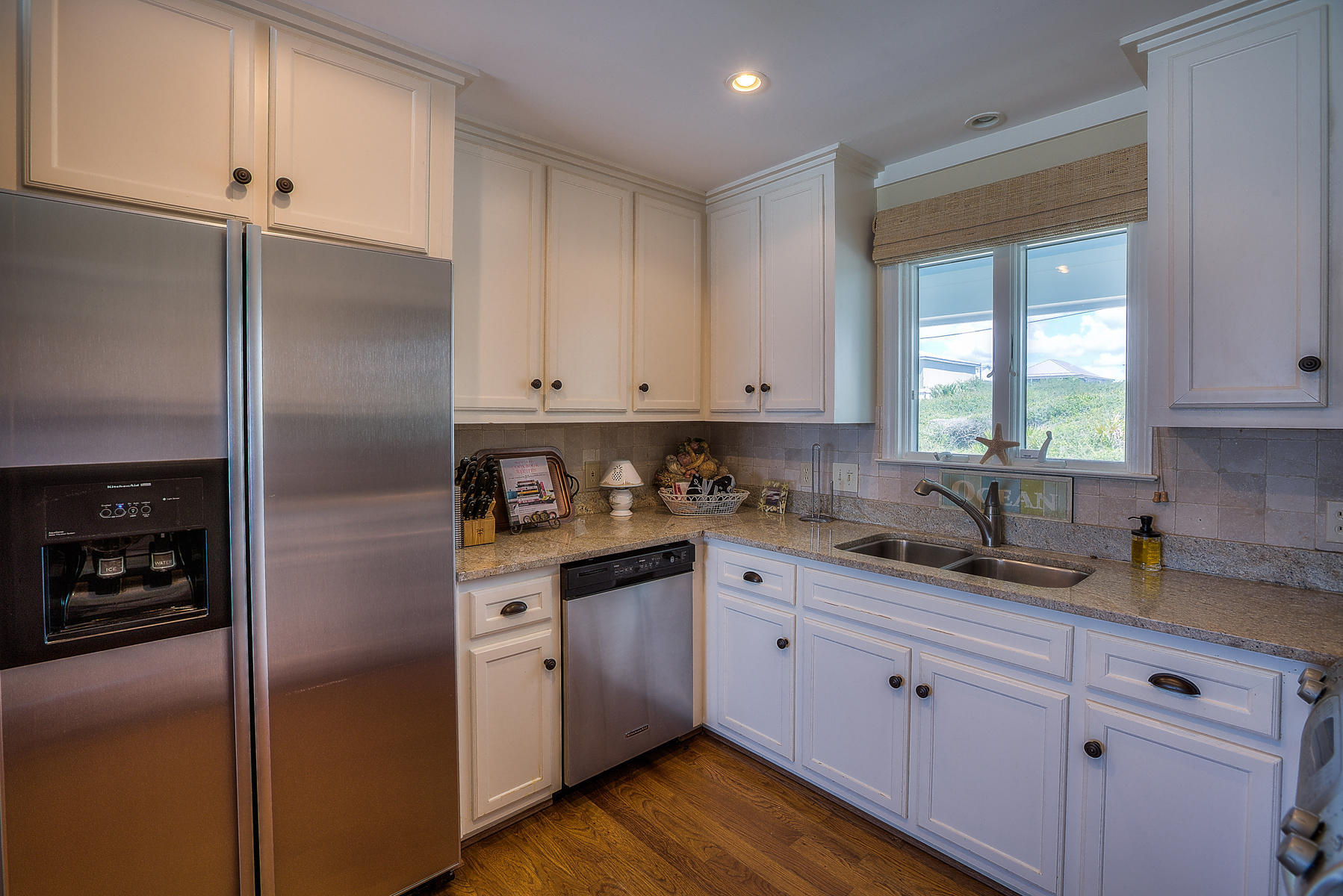 325 Pompano Street Inlet Beach, FL 32461 - Photo 11 of 49 a kitchen with white cabinets and white appliances