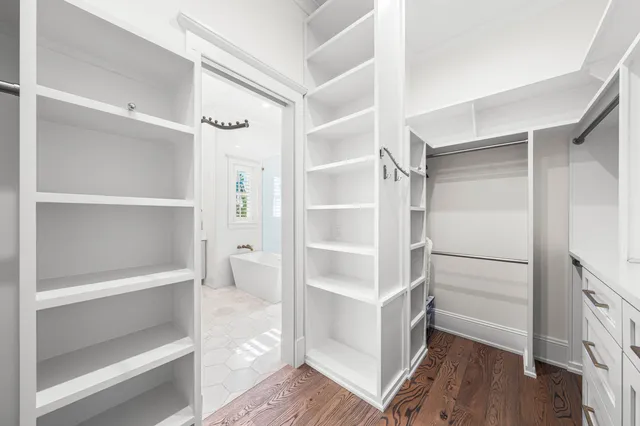 a view of staircase with wooden floor and white walls