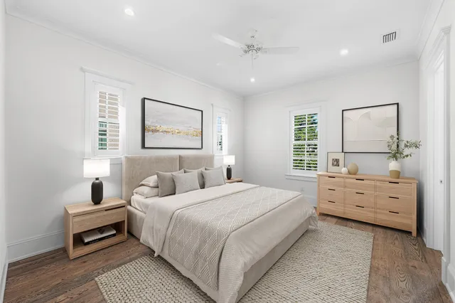 a dining room with wooden floor a chandelier a wooden table and chairs