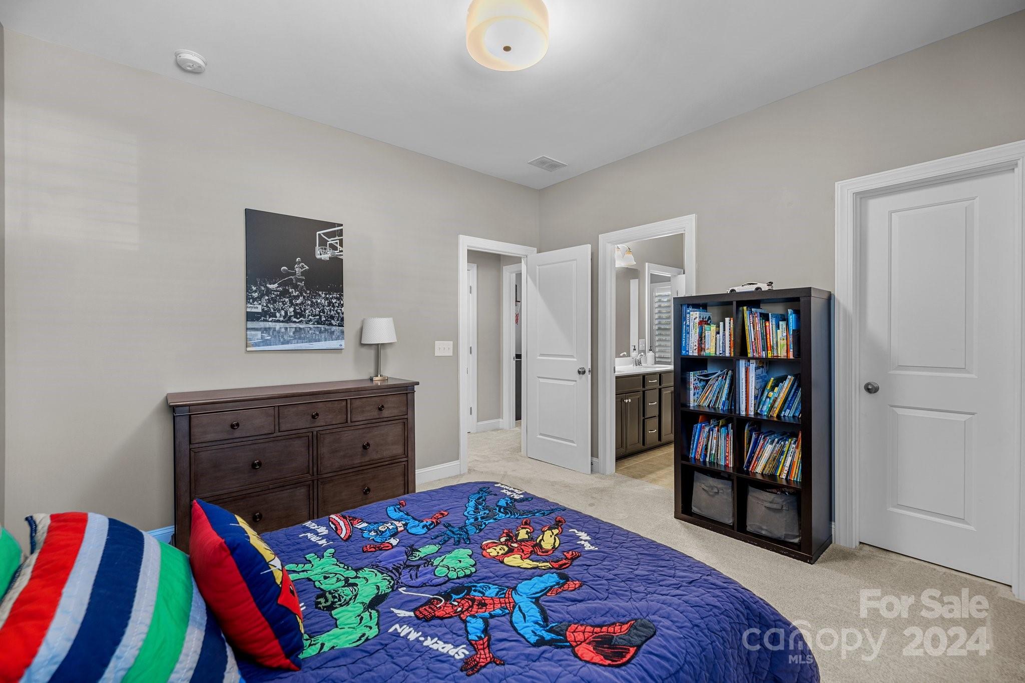 470 Langston Pl Drive Fort Mill, SC 29708 - Photo 25 of 40 a bedroom with a bed a dresser and book shelf