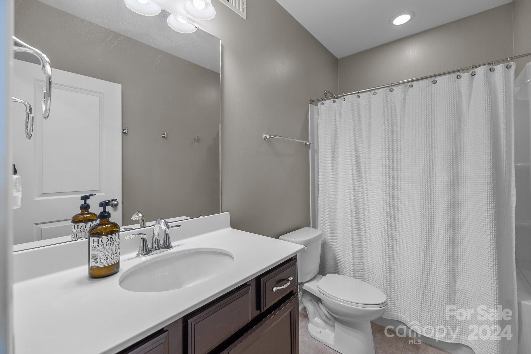 470 Langston Pl Drive Fort Mill, SC 29708 - Photo 28 of 40 a bathroom with a sink a toilet and shower curtain