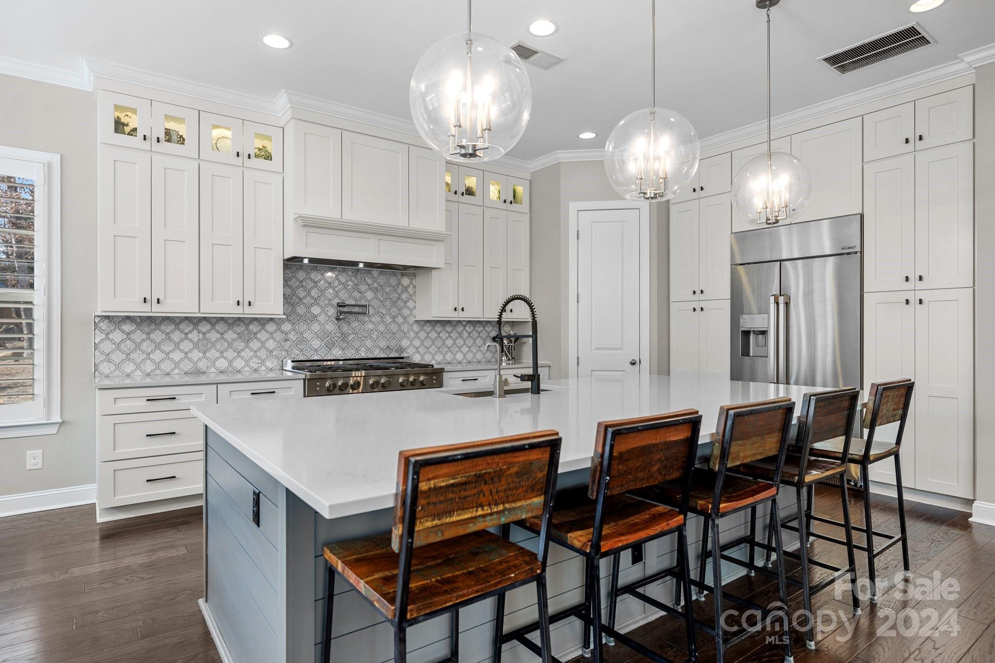 470 Langston Pl Drive Fort Mill, SC 29708 - Photo 7 of 40 a kitchen with cabinets appliances and a chandelier