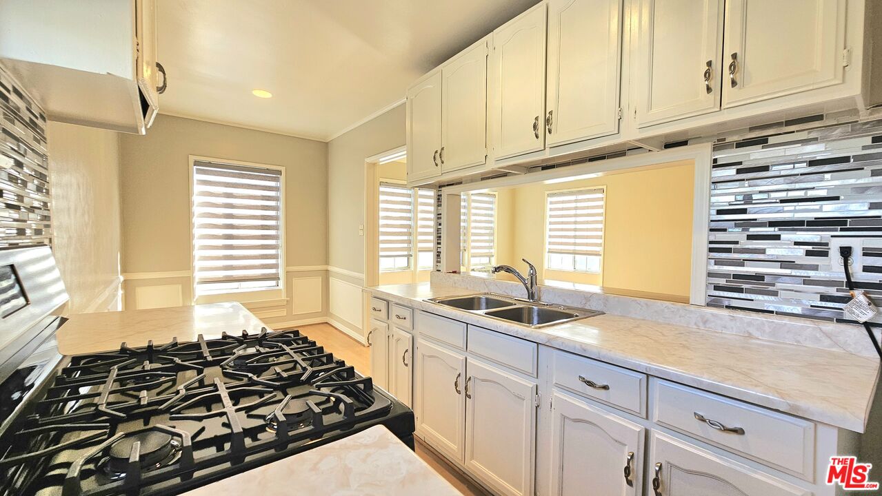 a kitchen with a sink stove and cabinets