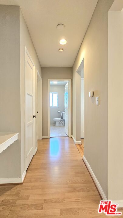 1022 South Norton Avenue, Unit C Los Angeles, CA 90019 - Photo 21 of 43 a view of a hallway with bathroom and wooden floor