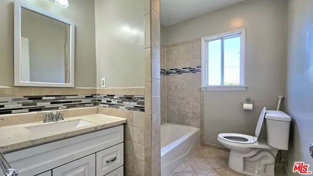 a bathroom with a sink a toilet and a bathtub