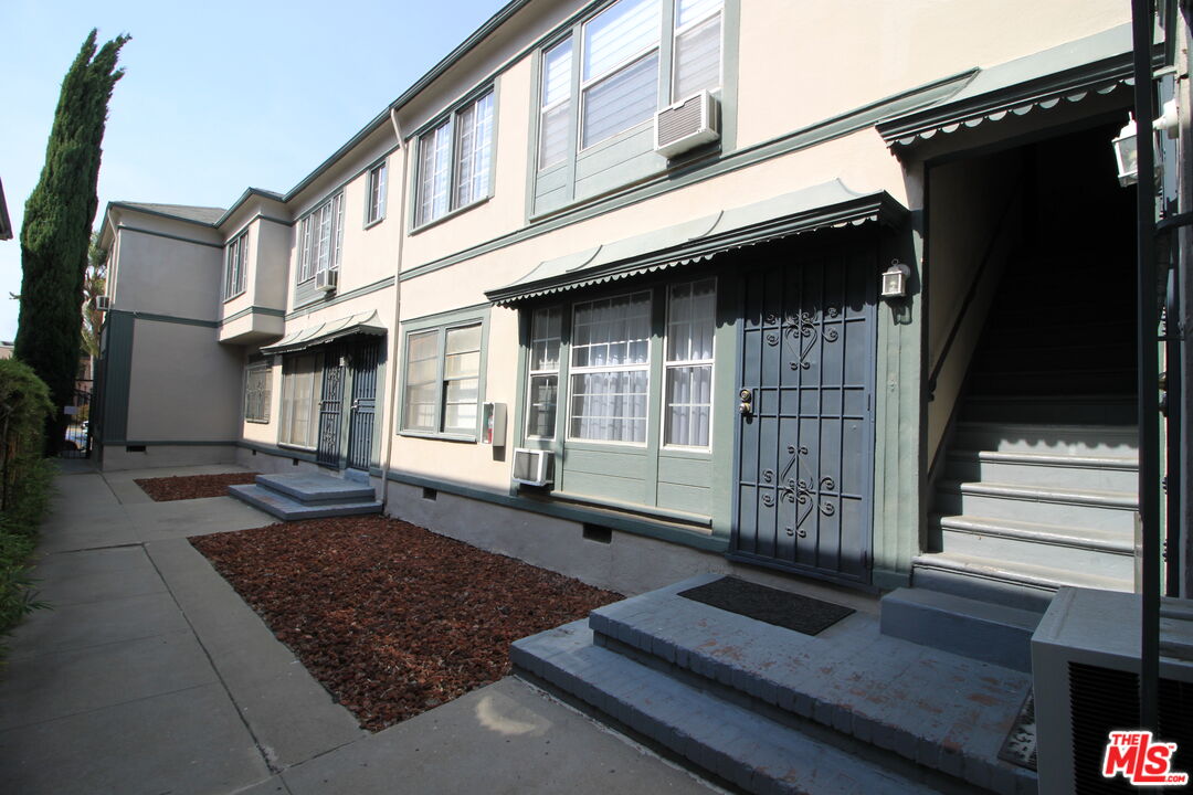 1022 South Norton Avenue, Unit C Los Angeles, CA 90019 - Photo 36 of 43 a view of a house with a door and a window