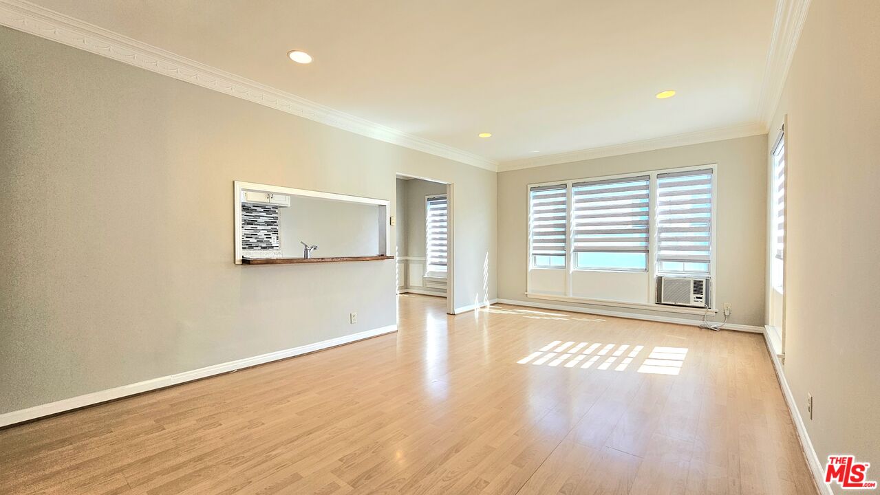 1022 South Norton Avenue, Unit C Los Angeles, CA 90019 - Photo 7 of 43 a view of an empty room with wooden floor and a window