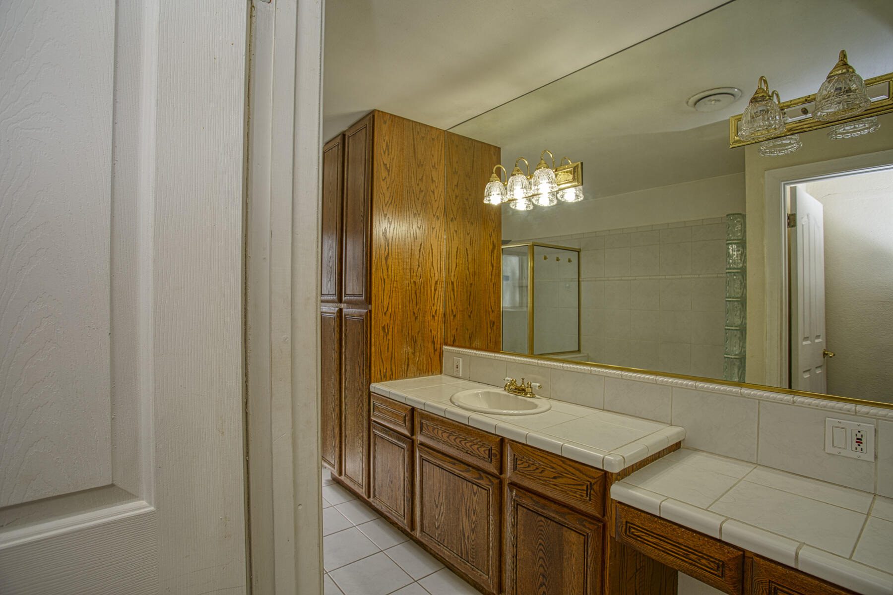 17829 Ranchera Road Shasta Lake, CA 96019 - Photo 14 of 39 a bathroom with a double vanity sink and a mirror