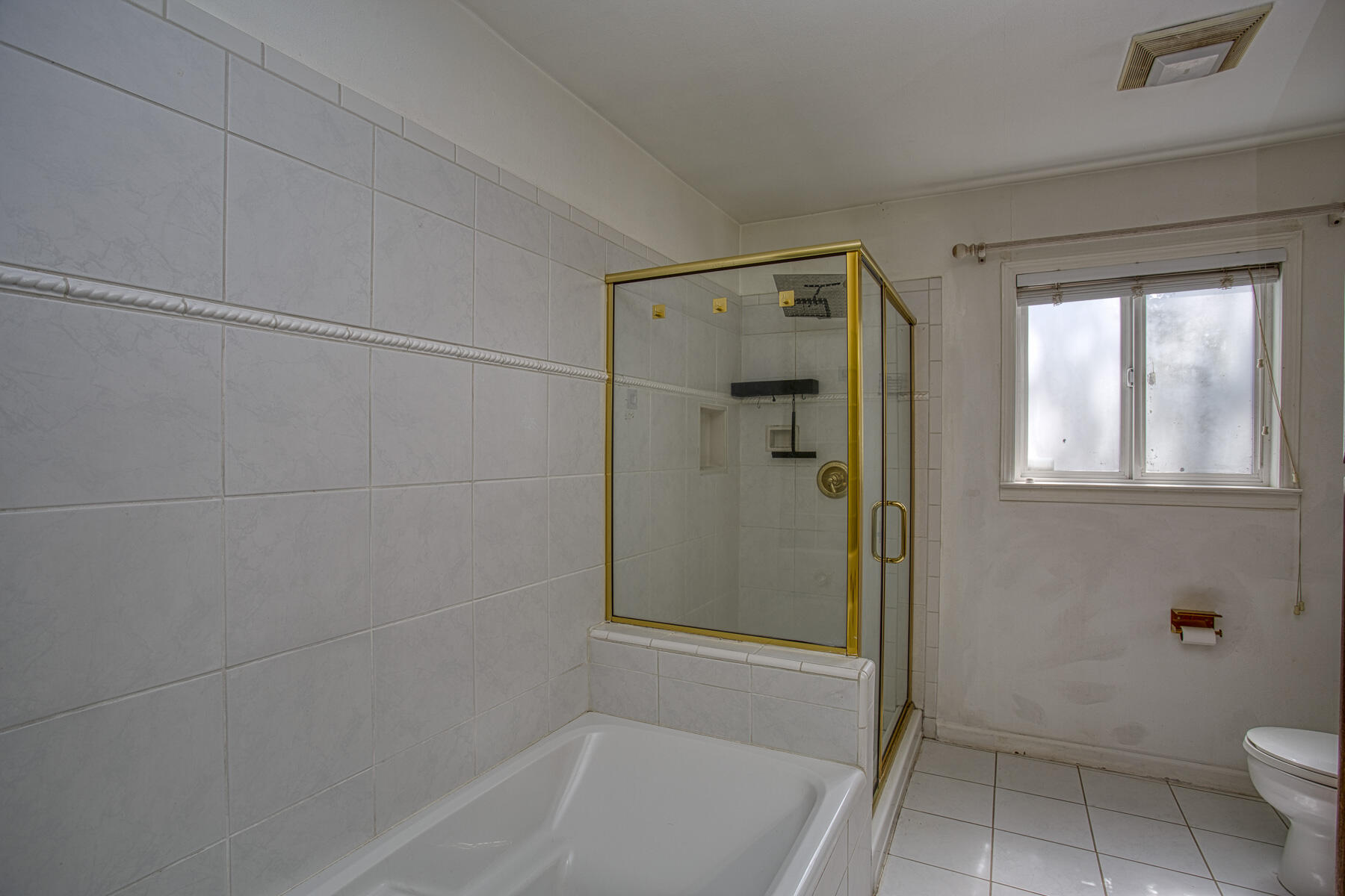 17829 Ranchera Road Shasta Lake, CA 96019 - Photo 15 of 39 a bathroom with a granite countertop bathtub a toilet and a shower
