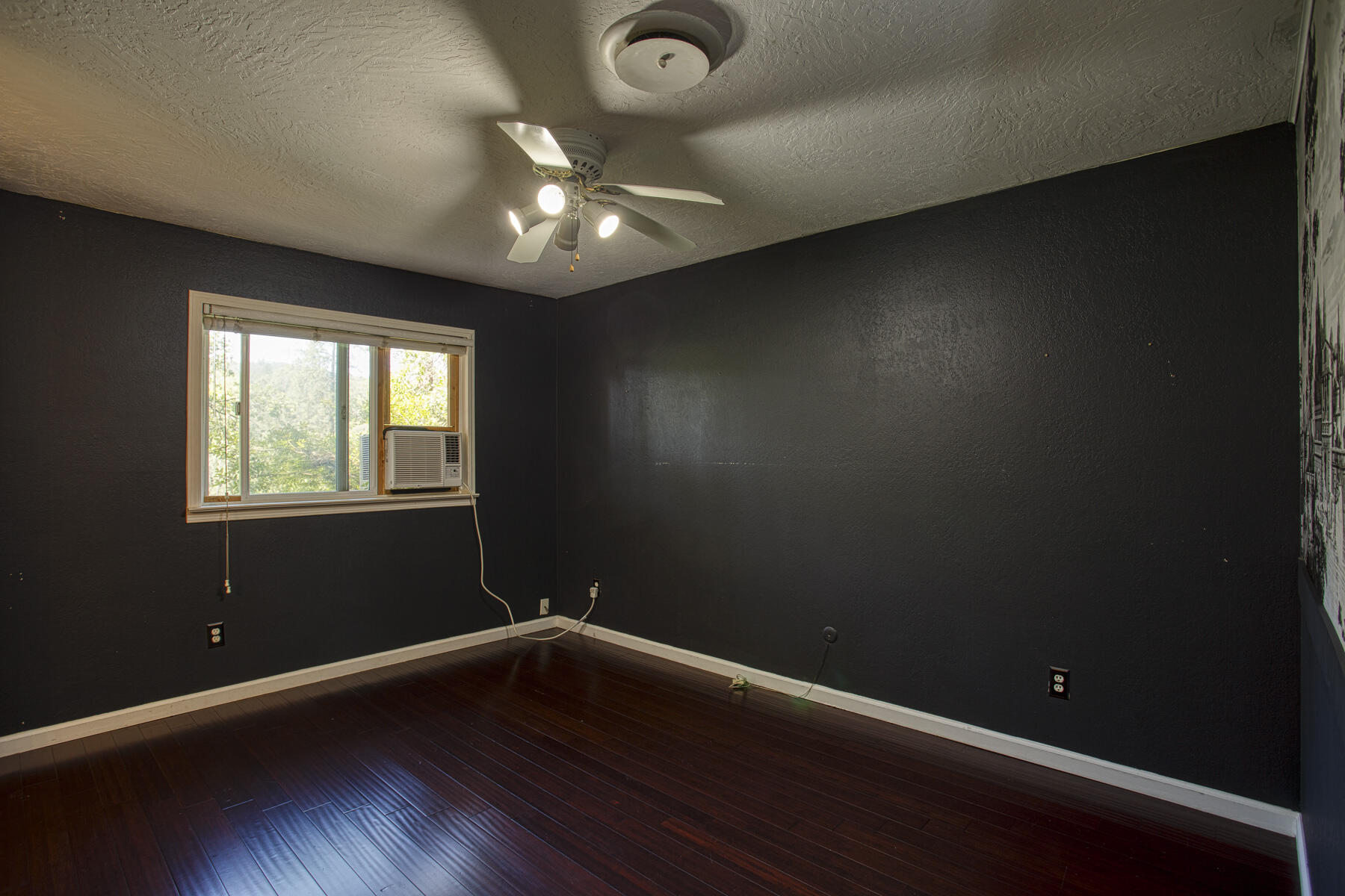 17829 Ranchera Road Shasta Lake, CA 96019 - Photo 16 of 39 an empty room with wooden floor and windows