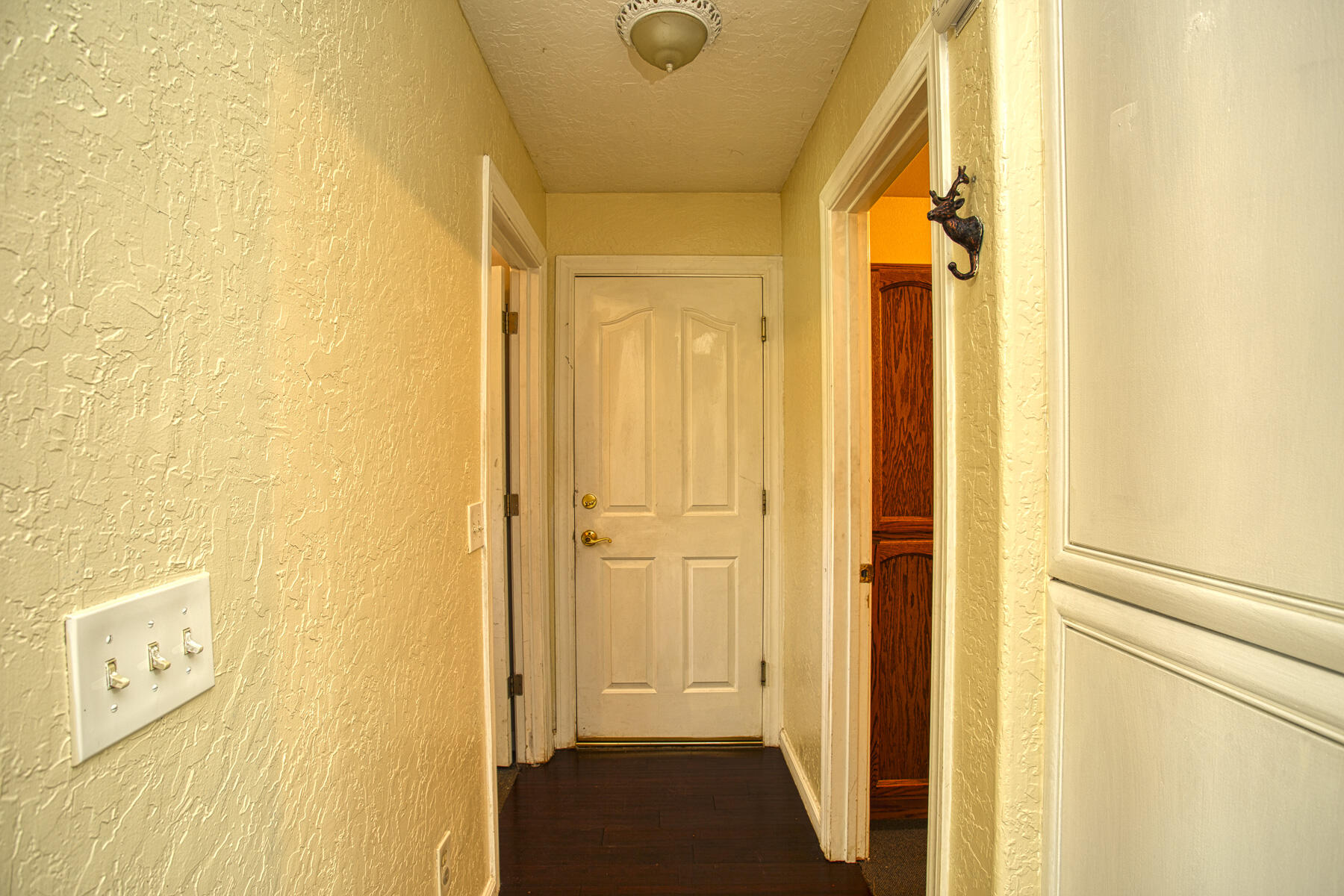 17829 Ranchera Road Shasta Lake, CA 96019 - Photo 30 of 39 a view of a hallway with wooden floor and closet
