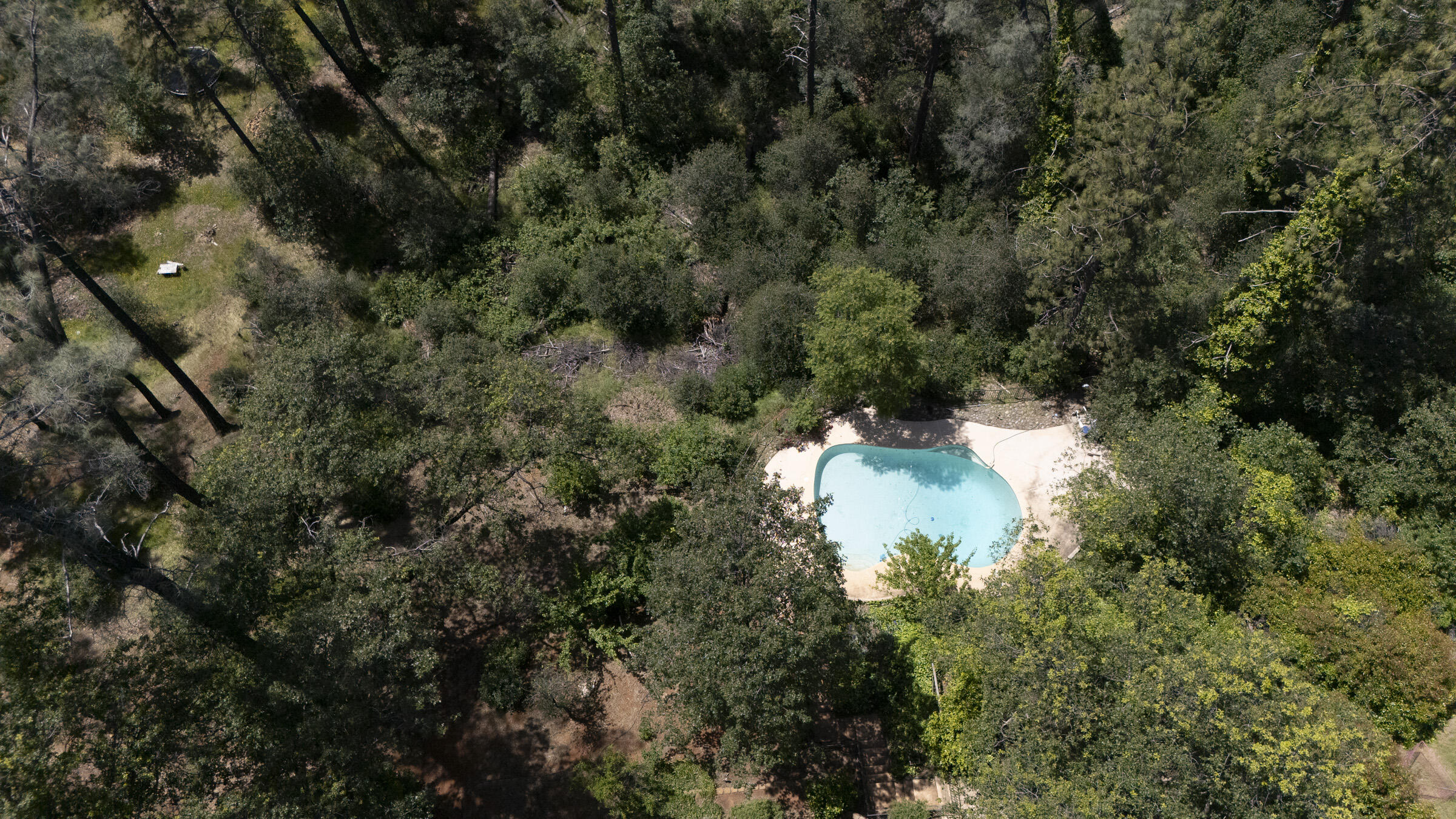 17829 Ranchera Road Shasta Lake, CA 96019 - Photo 34 of 39 an aerial view of a house with a yard and trees all around