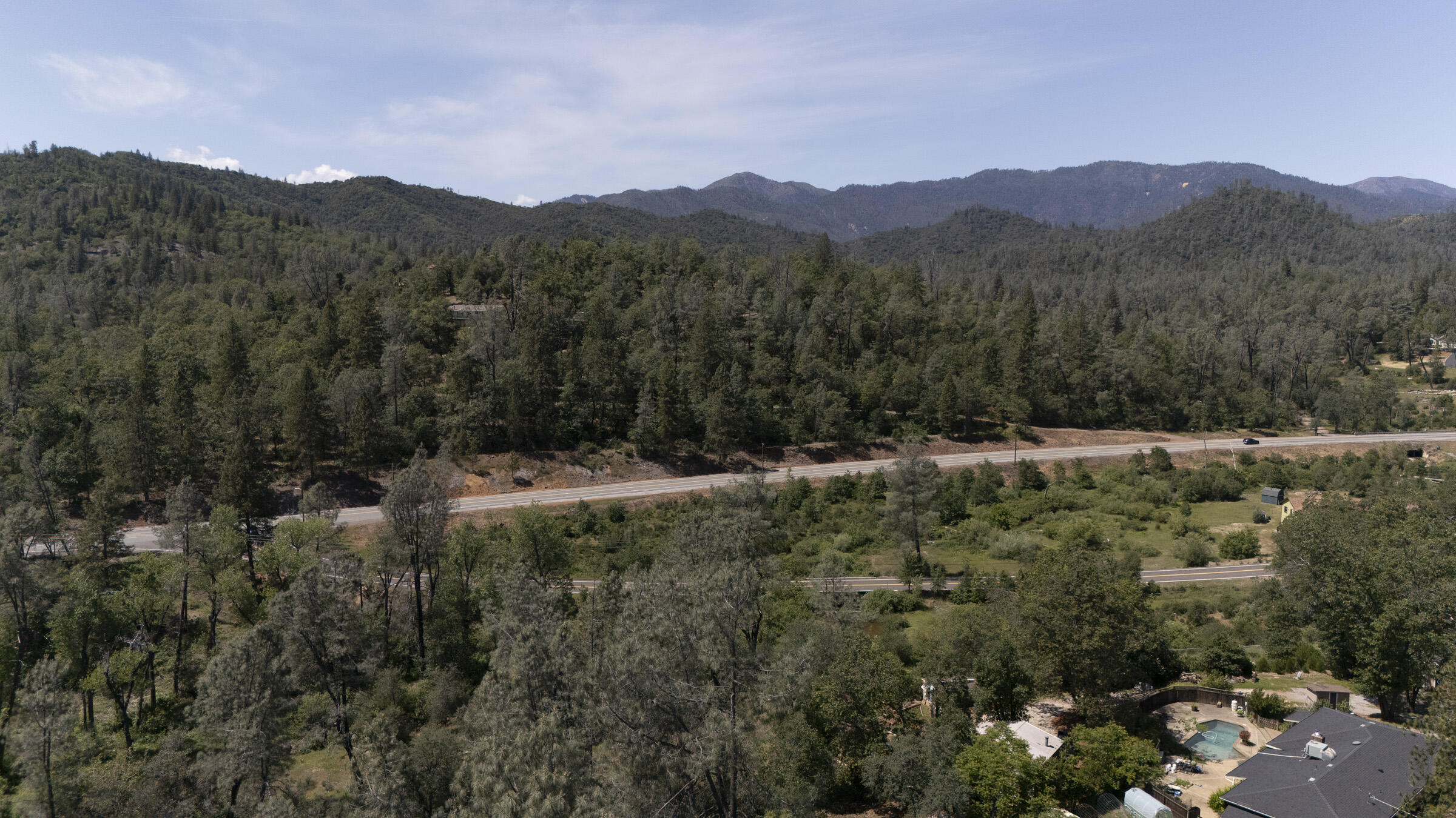 17829 Ranchera Road Shasta Lake, CA 96019 - Photo 37 of 39 a view of a lush green hillside and a building