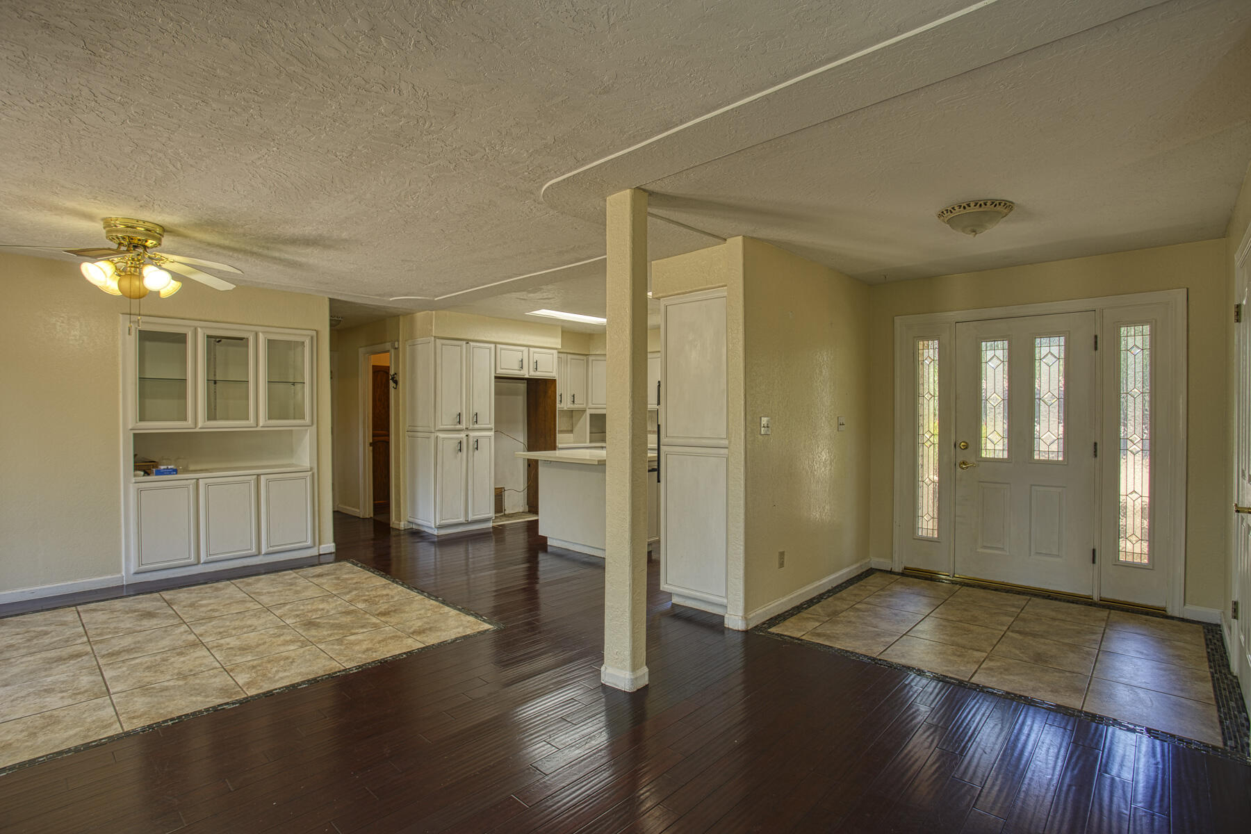 17829 Ranchera Road Shasta Lake, CA 96019 - Photo 5 of 39 an empty room with wooden floor and windows