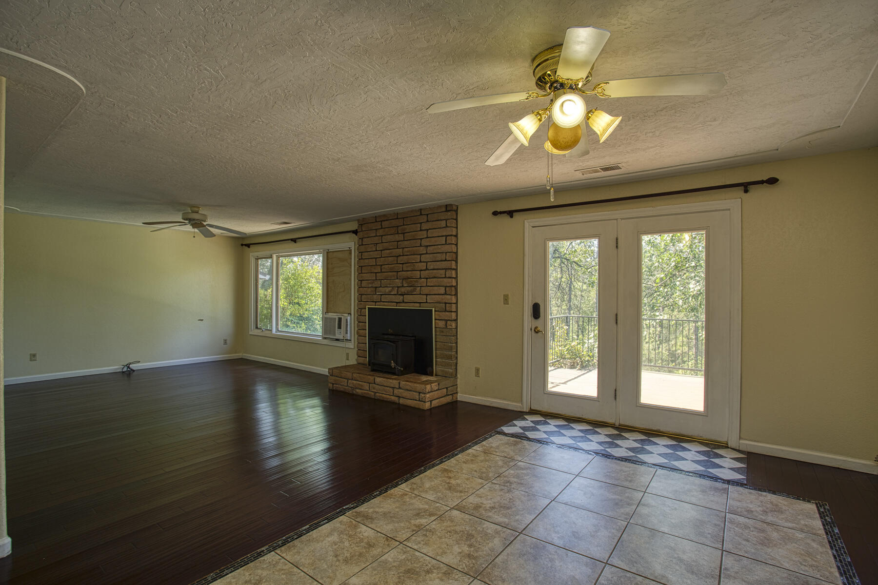 17829 Ranchera Road Shasta Lake, CA 96019 - Photo 9 of 39 a view of an empty room with window and wooden floor