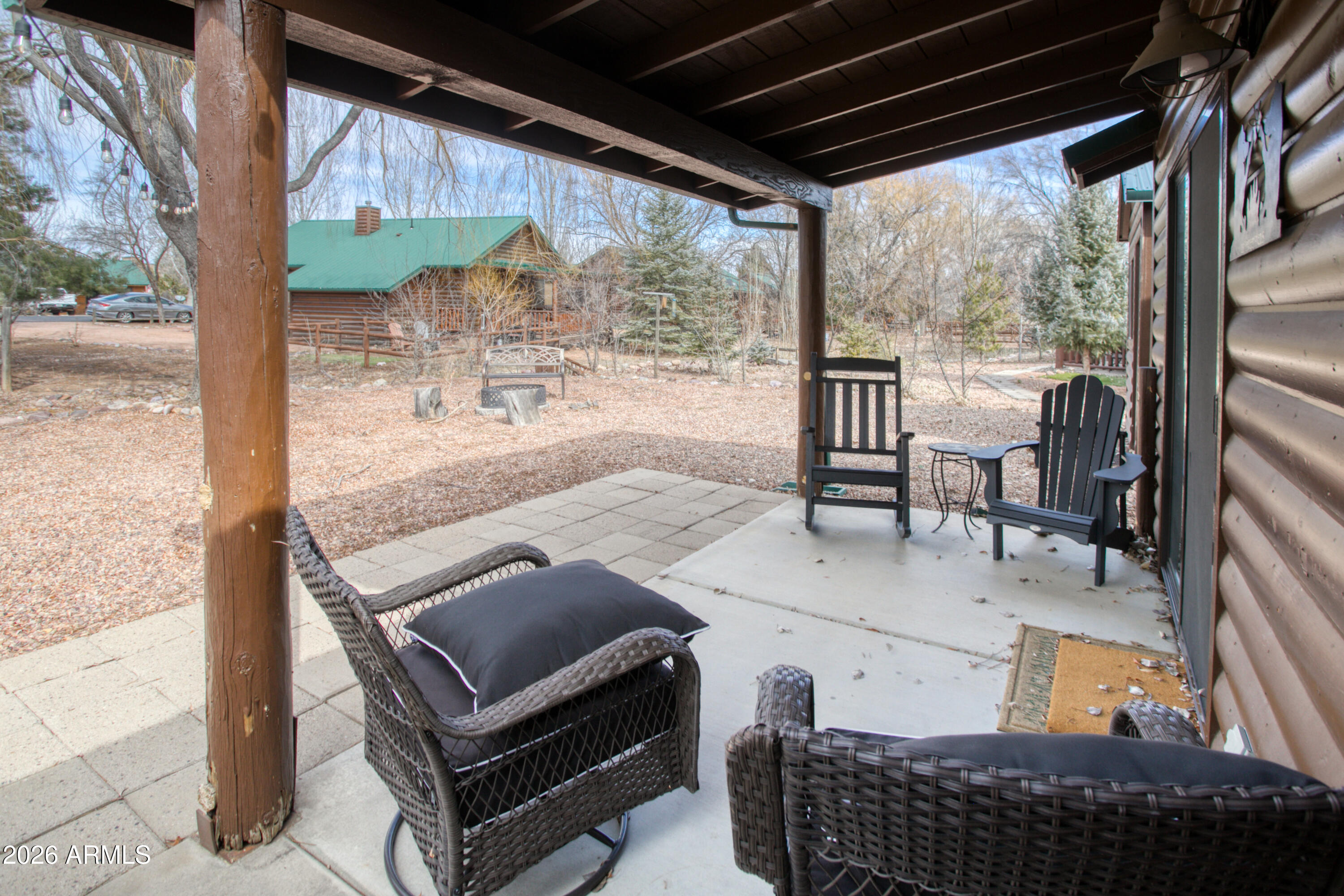 2342 South Buffalo Loop Overgaard, AZ 85933 - Photo 18 of 27 a backyard of a house with outdoor seating