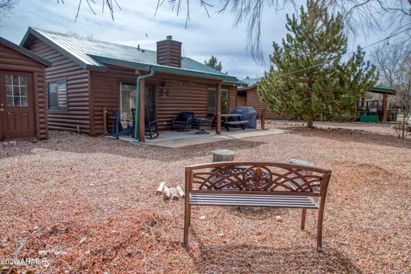 a view of a chairs and table in the backyard