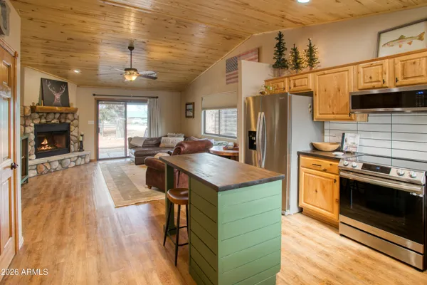 a kitchen with stainless steel appliances granite countertop a stove refrigerator and a microwave oven