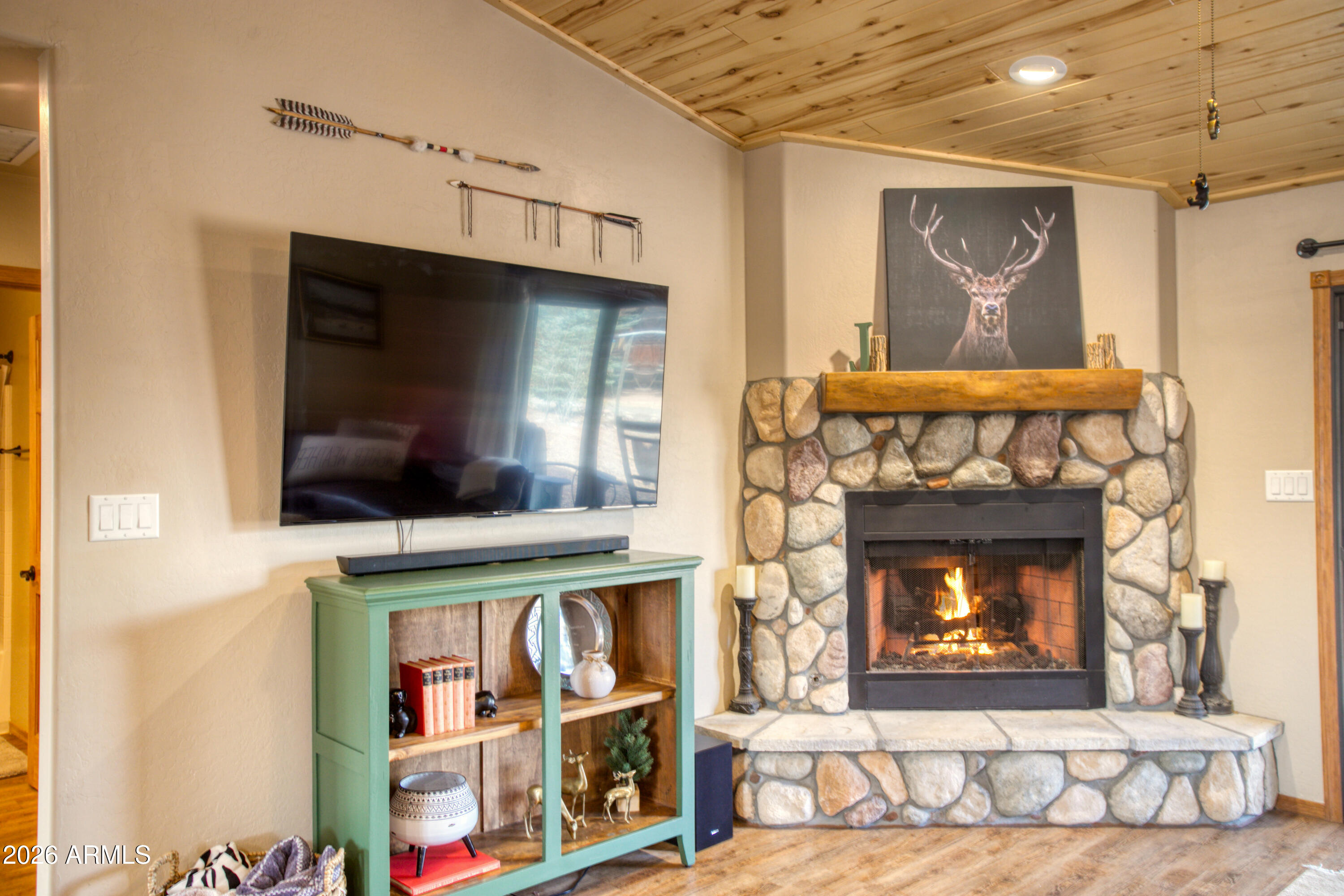 2342 South Buffalo Loop Overgaard, AZ 85933 - Photo 9 of 27 a living room with fireplace and a fireplace