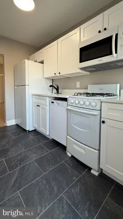 a kitchen with appliances cabinets and a sink
