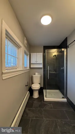 a bathroom with a toilet and a shower