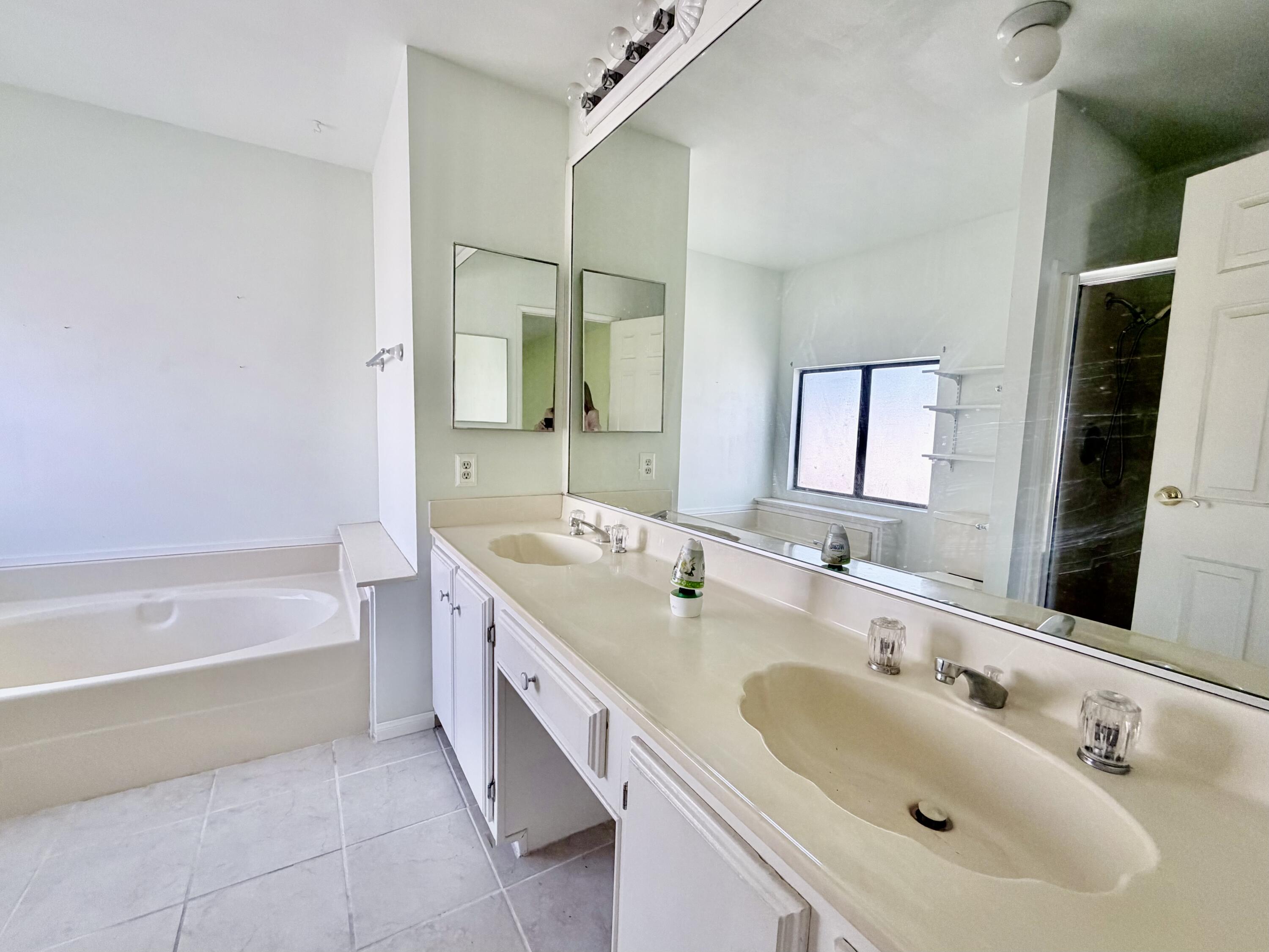 74361 Angel Camp Road Palm Desert, CA 92260 - Photo 12 of 12 a spacious bathroom with a bathtub sink and mirror
