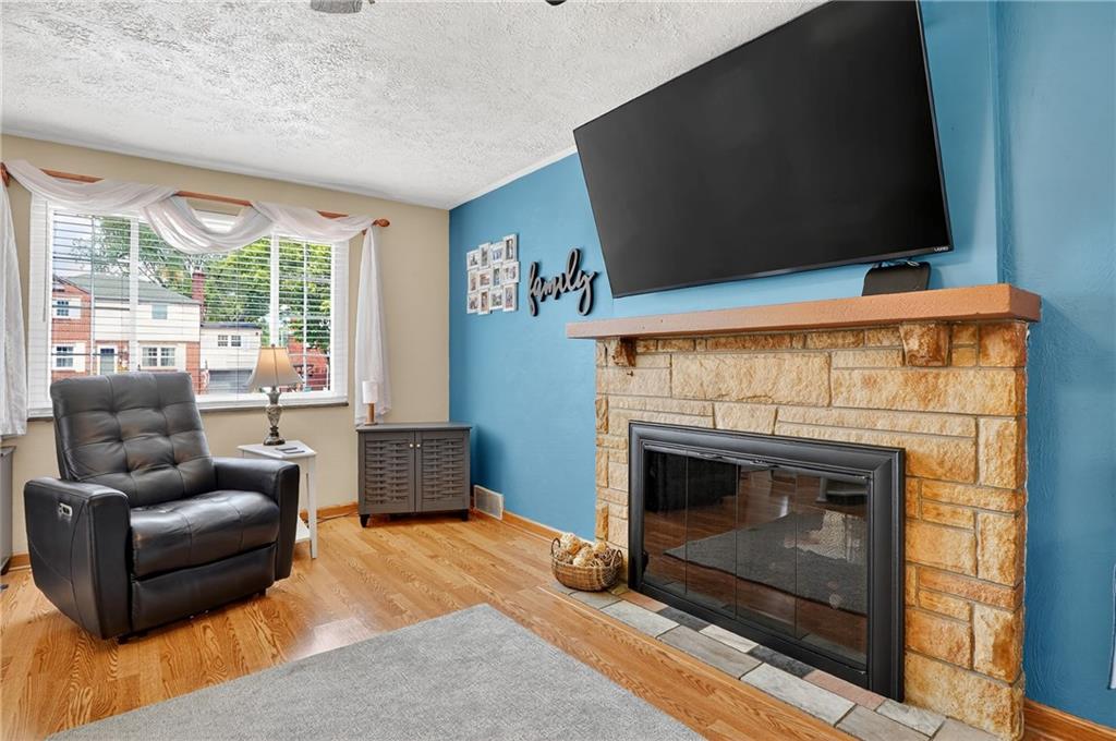 352 Spring Valley Road Pittsburgh, PA 15243 - Photo 3 of 33 a living room with furniture and a fireplace