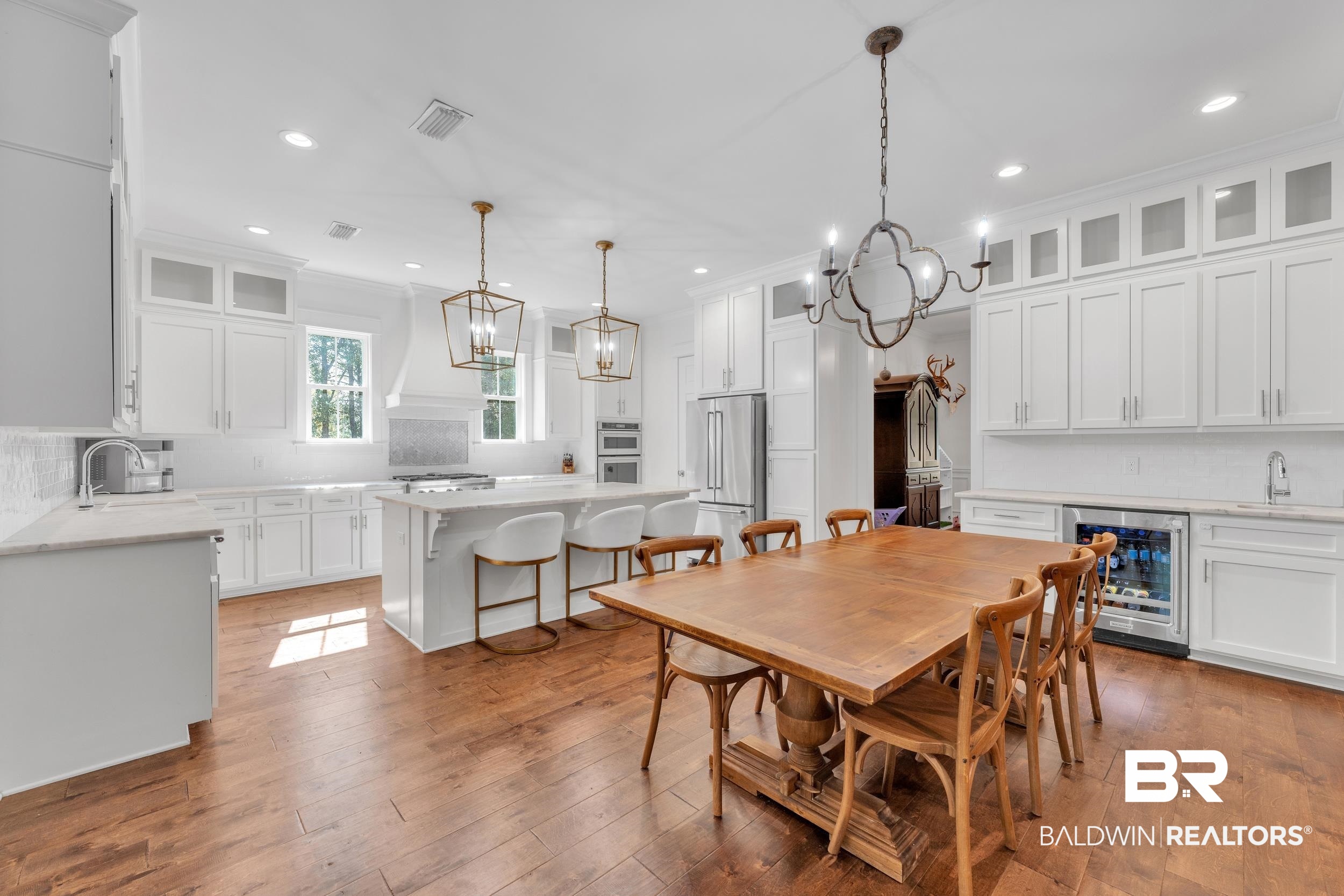 14531 Styx River Road Stapleton, AL 36578 - Photo 10 of 50 Dining area with beverage cooler, a chandelier, crown molding, recessed lighting, and wood-type flooring