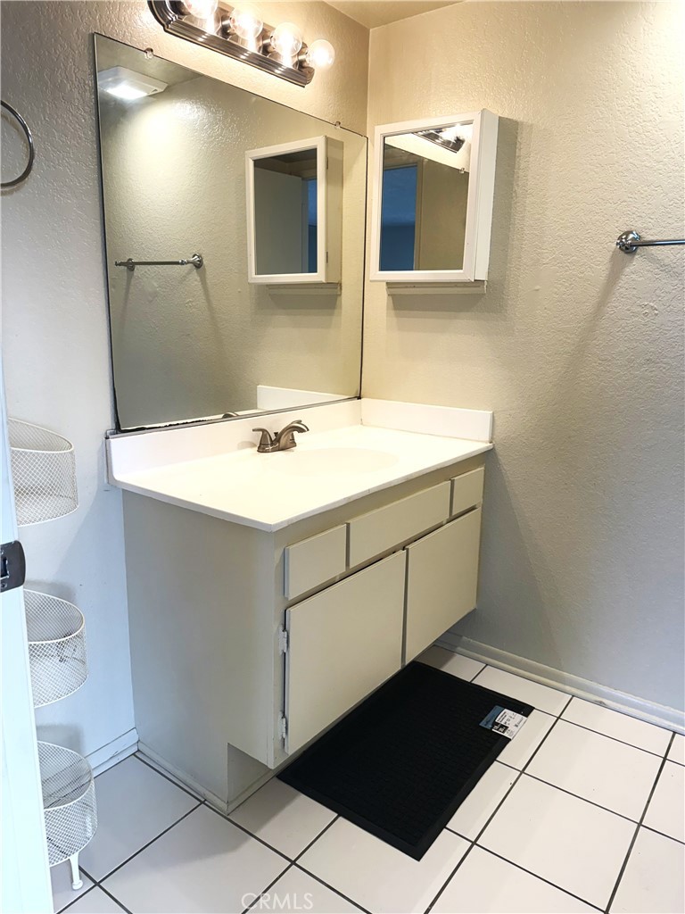 2511 Florida Street, Unit 1 Huntington Beach, CA 92648 - Photo 11 of 13 a bathroom with a sink and a mirror