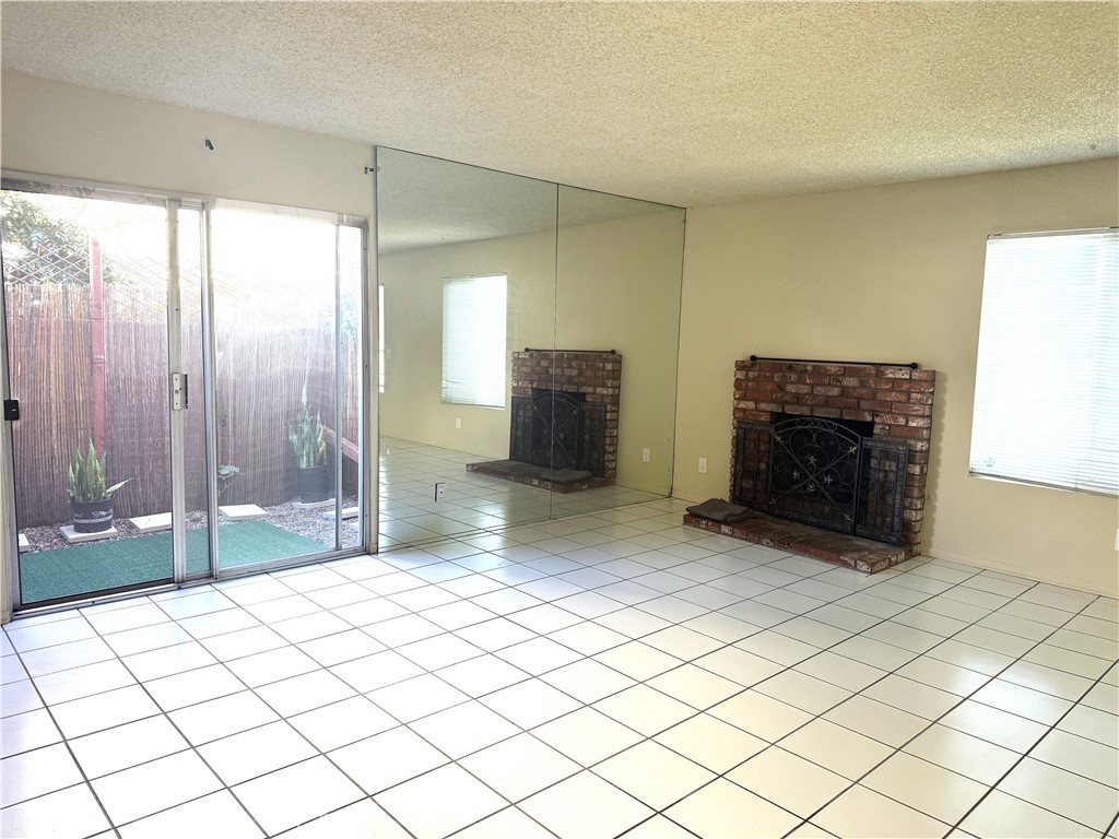 2511 Florida Street, Unit 1 Huntington Beach, CA 92648 - Photo 3 of 13 a spacious bedroom with a bed and a fireplace