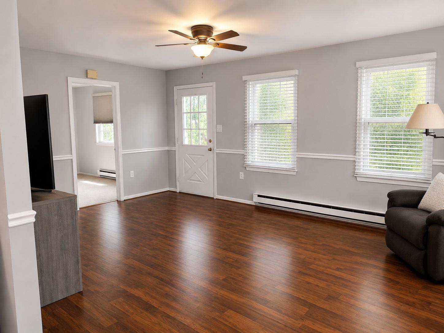 7006 Basswood Road Frederick, MD 21703 - Photo 4 of 10 a view of an empty room with wooden floor and a window