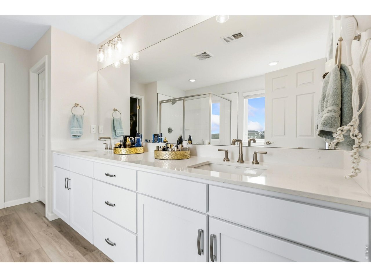 955 Rustling Street Windsor, CO 80550 - Photo 15 of 34 a bathroom with a sink double vanity granite and a mirror