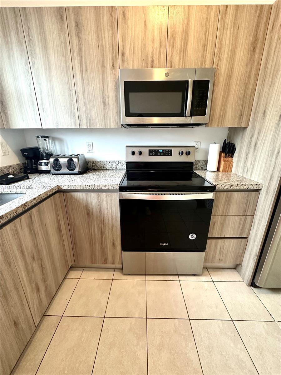1684 Southwest 10th Street Miami, FL 33135 - Photo 6 of 15 a kitchen with a stove top oven and cabinets