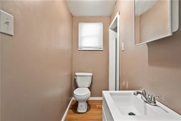 a white toilet sitting next to a bathroom sink