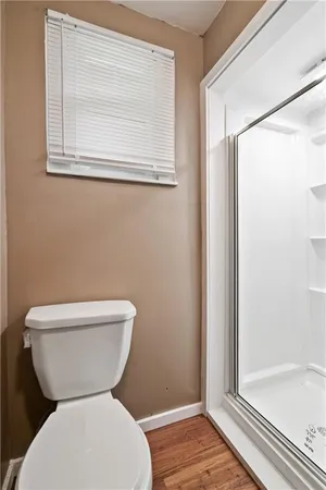 a white toilet sitting next to a bathroom sink