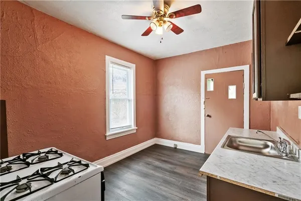 a kitchen with a stove and a granite counter tops