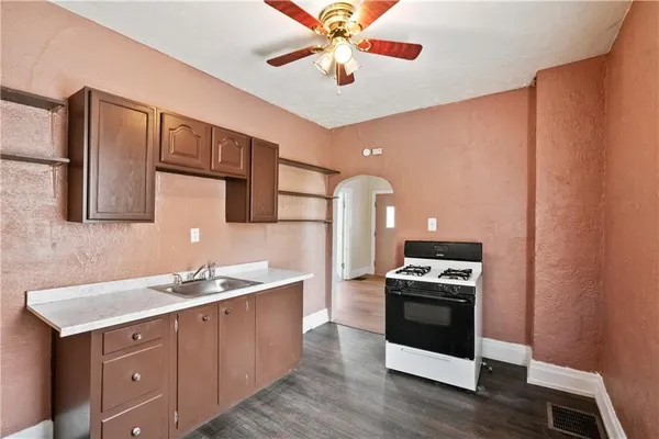 a kitchen with a sink appliances and cabinets