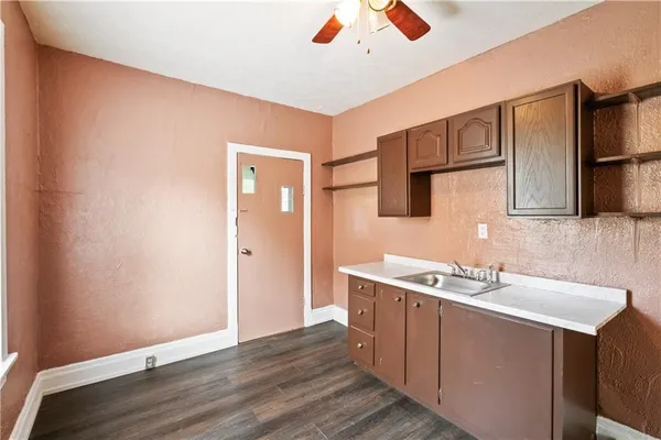 a room with a sink cabinets and wooden floor